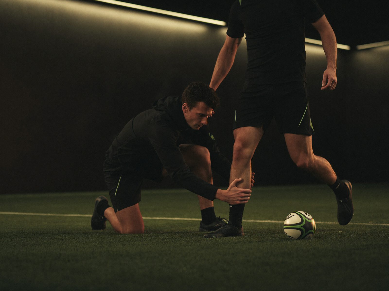 Fisioterapeuta de Kinetia atendiendo a un jugador de rugby en el campo